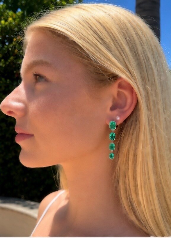 Profile view of the Columbian Rain platinum drop earring with its cascade of lab-grown emeralds