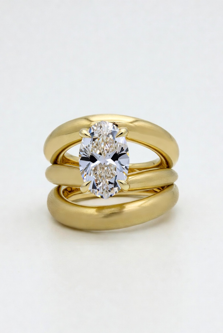 Oval lab-grown diamond solitaire stacked between two chunky polished yellow gold bands